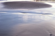 An elegant aquatic design showcasing a sandy lagoon with subtle lighting at dusk.