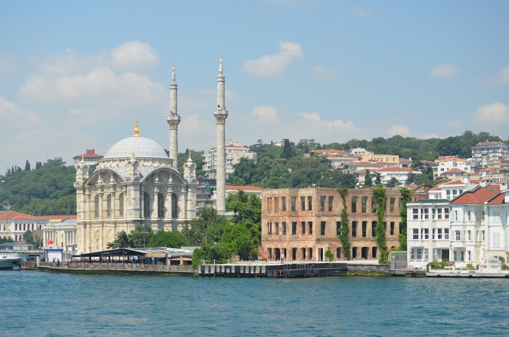 white and brown concrete building near body of water during daytime