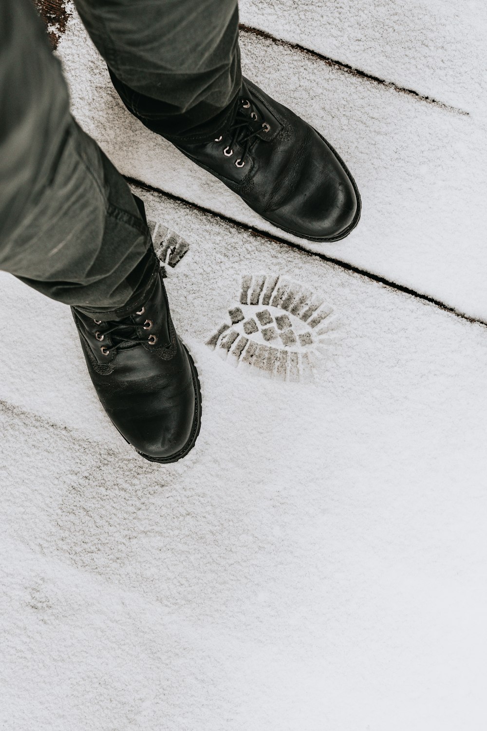 person wearing black leather shoes