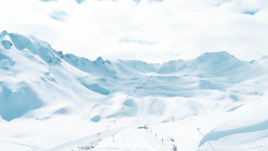 snow covered mountain under cloudy sky during daytime in Val-d'Isère France