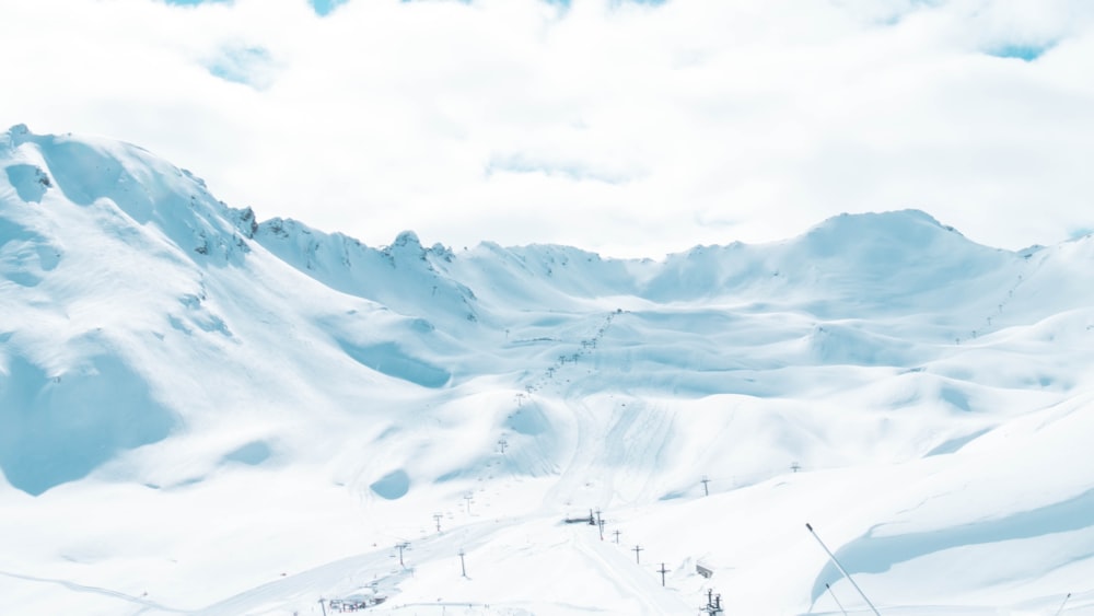 snow covered mountain under cloudy sky during daytime