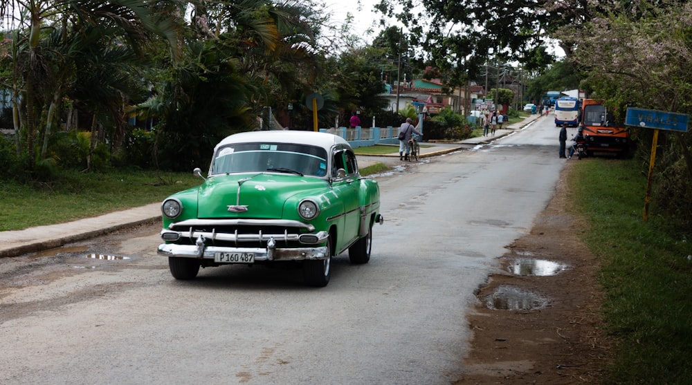 green classic car on road during daytime