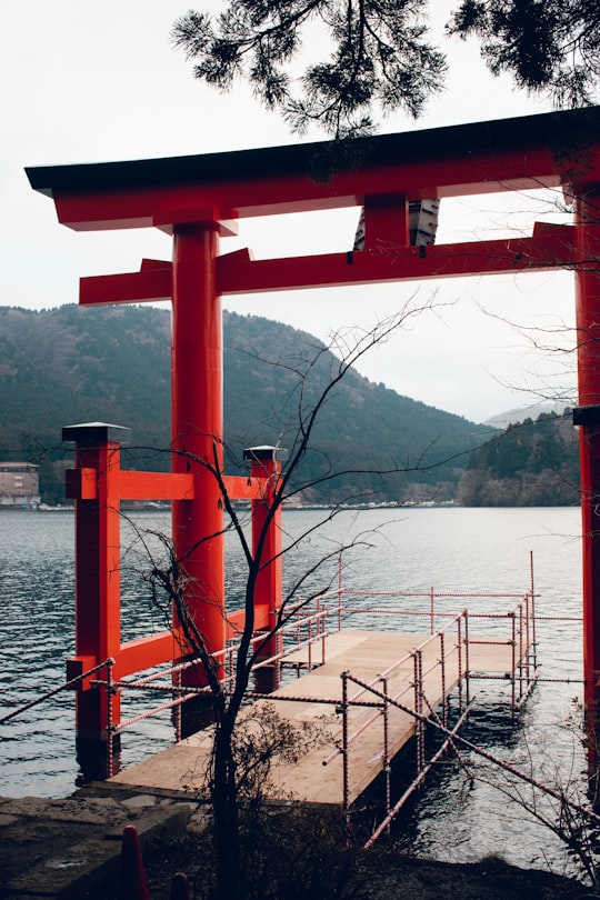 red metal bridge over the lake in Hakone Shrine Japan