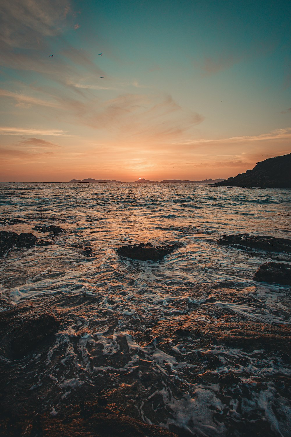 body of water during sunset