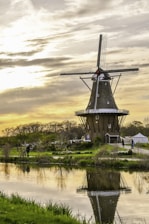 windmill near body of water during daytime