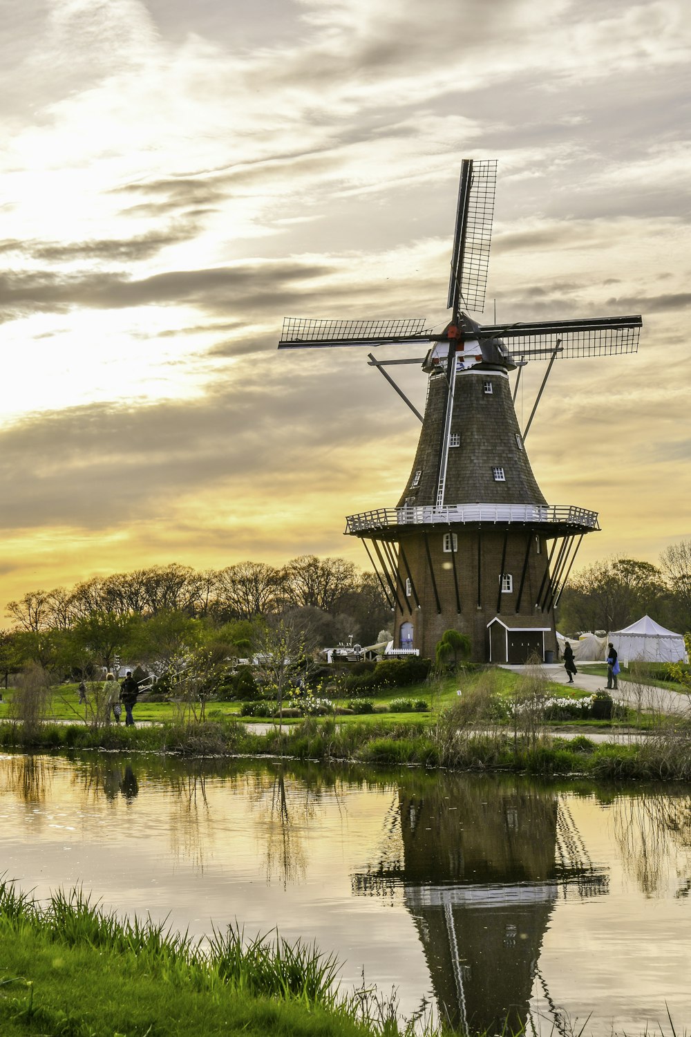 windmill near body of water during daytime