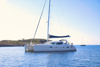 white and black sail boat on sea during daytime