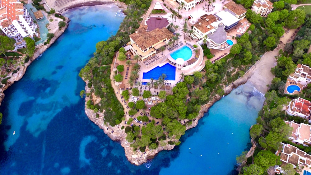 aerial view of white and blue building near body of water during daytime