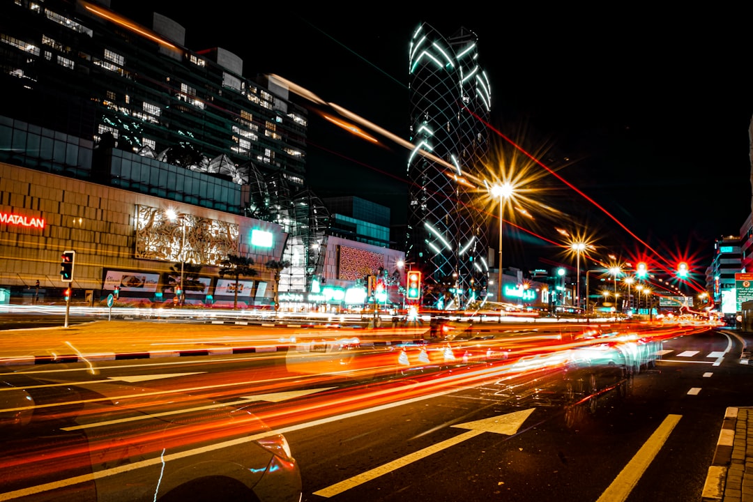 cars on road near buildings during night time