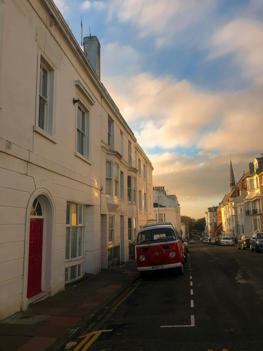 red bus on road near building during daytime