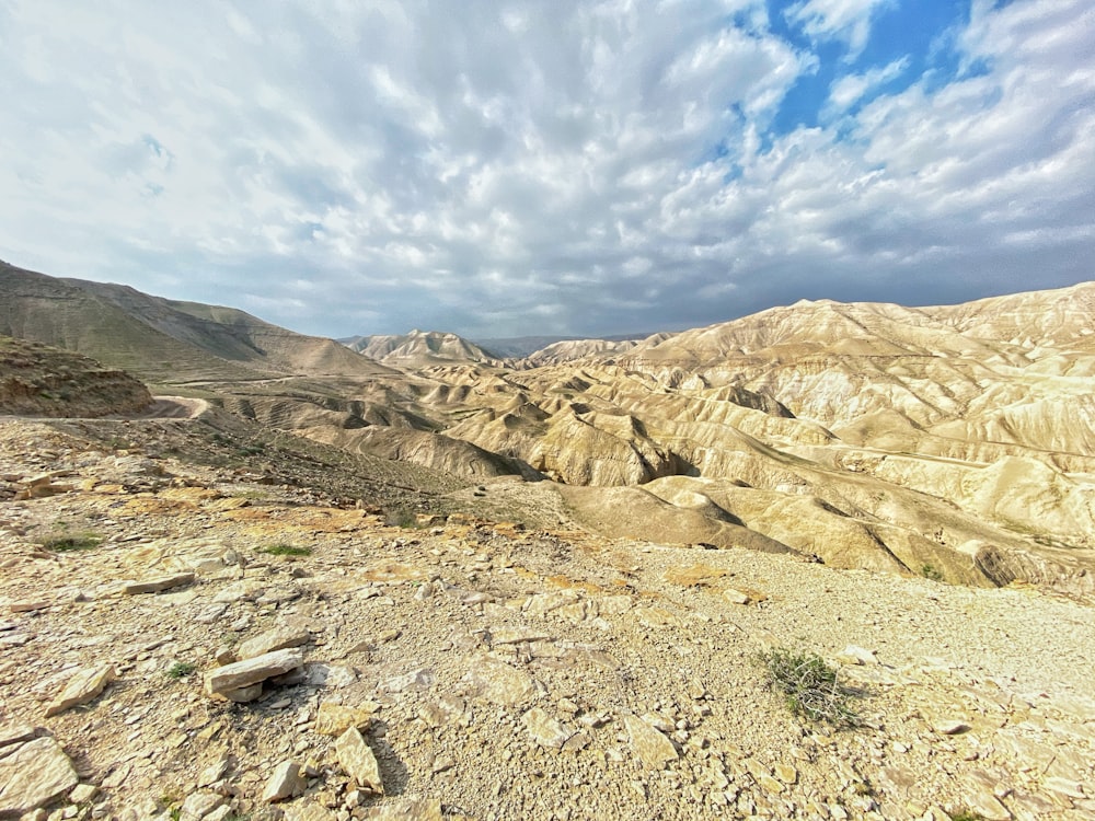 brown rocky mountain under blue sky and white clouds during daytime