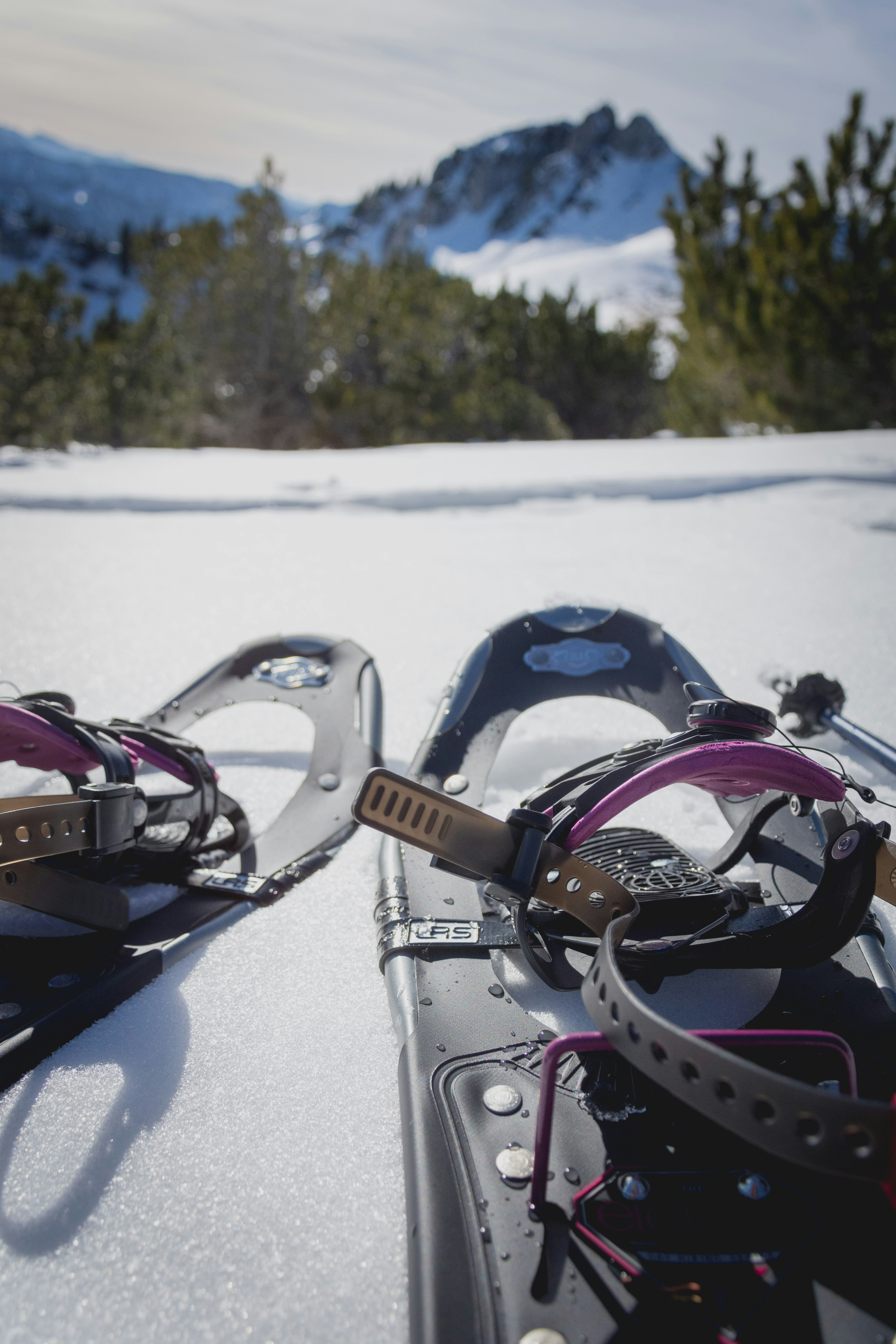 black and white snow goggles on snow covered ground