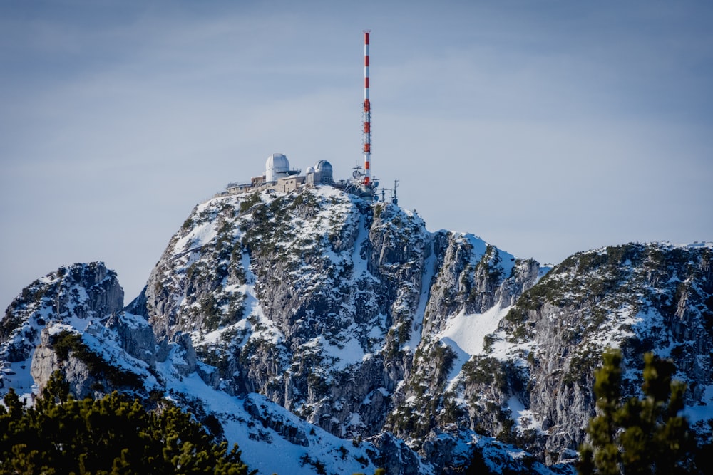 white and red tower on top of mountain