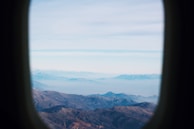 Aerial shot of a mountain range taken by a GPS-assisted drone on a clear day.
