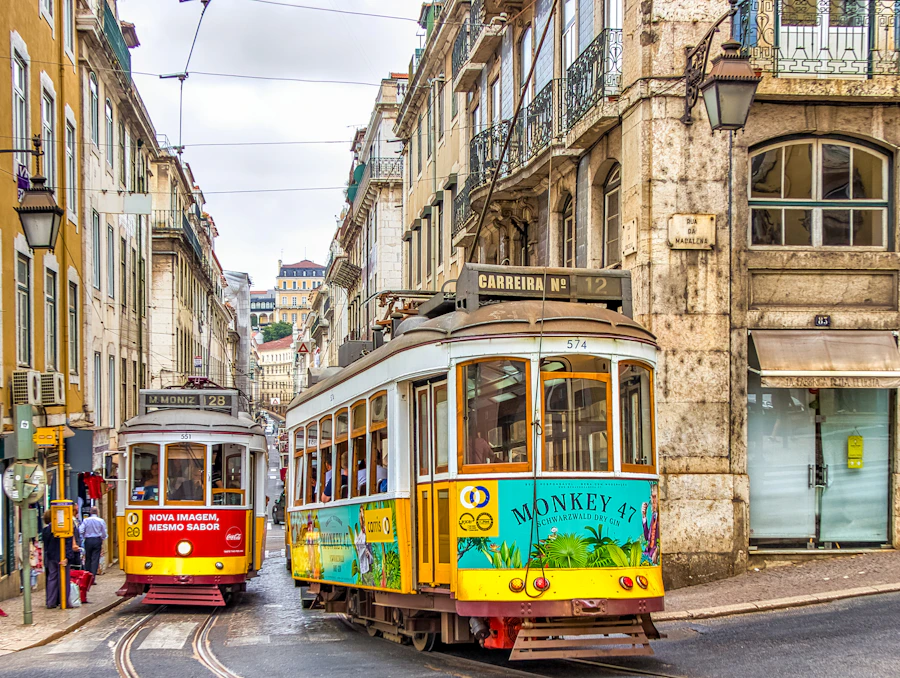 Yellow tram on a hilly street in Lisbon