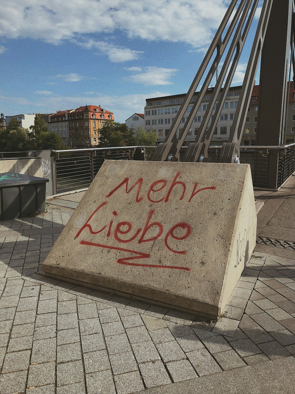 gray and red love me printed concrete signage