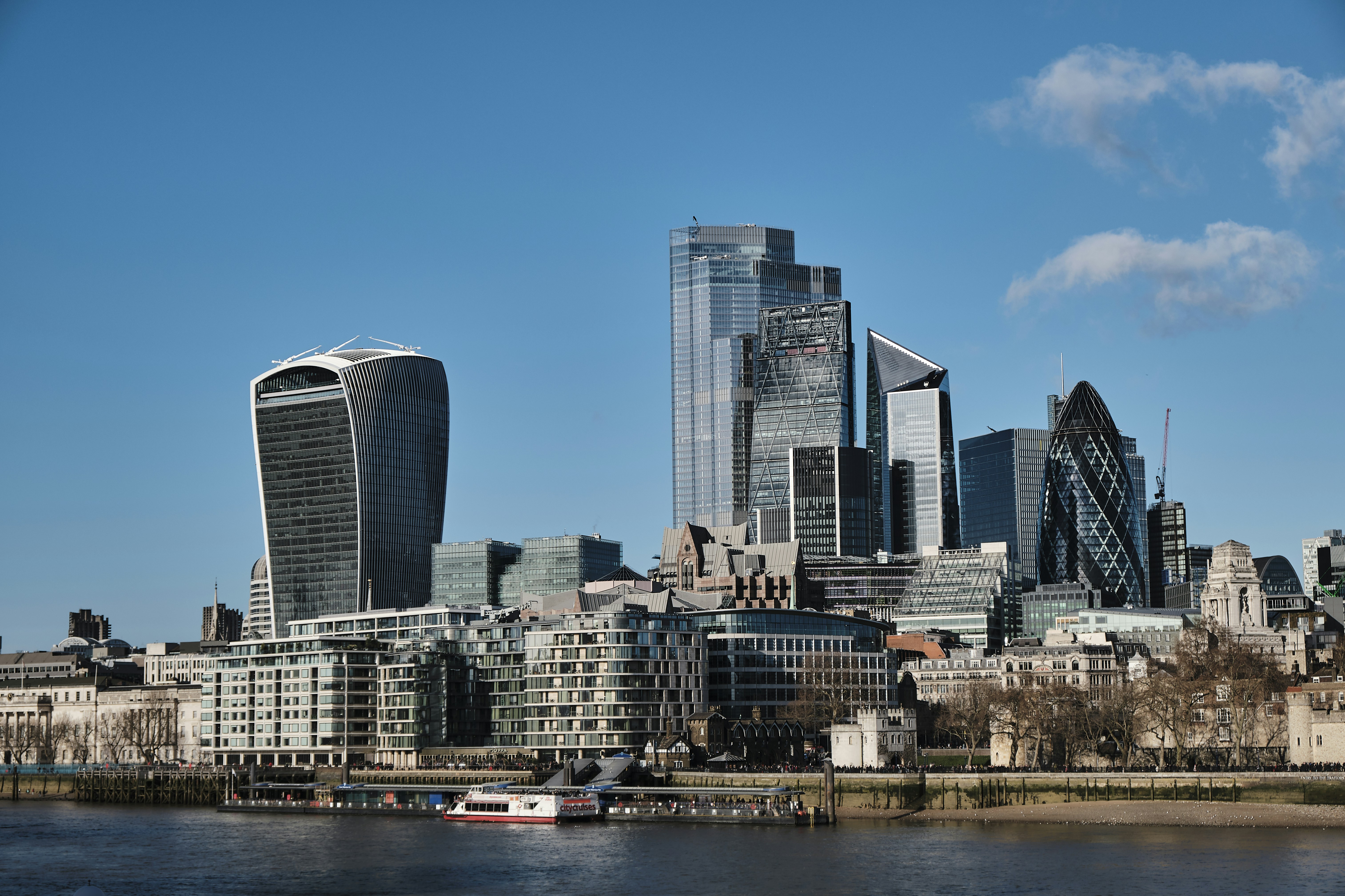 city skyline under blue sky during daytime, Sunny photo of the London skyline, taken from the Tower Bridge.
