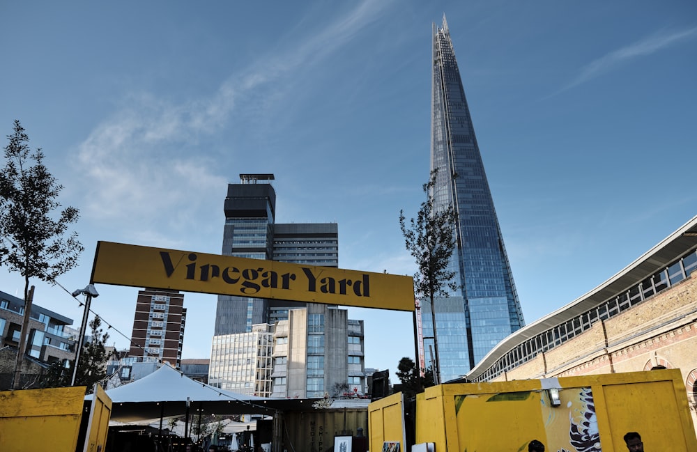 yellow and black heavy equipment near high rise building during daytime