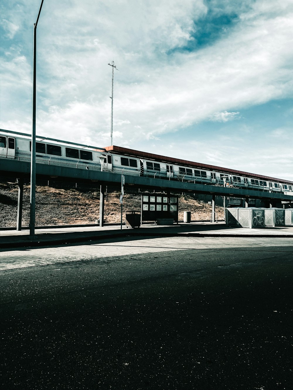 white and blue train under cloudy sky during daytime