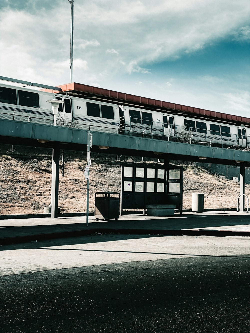 white and black train under white clouds during daytime