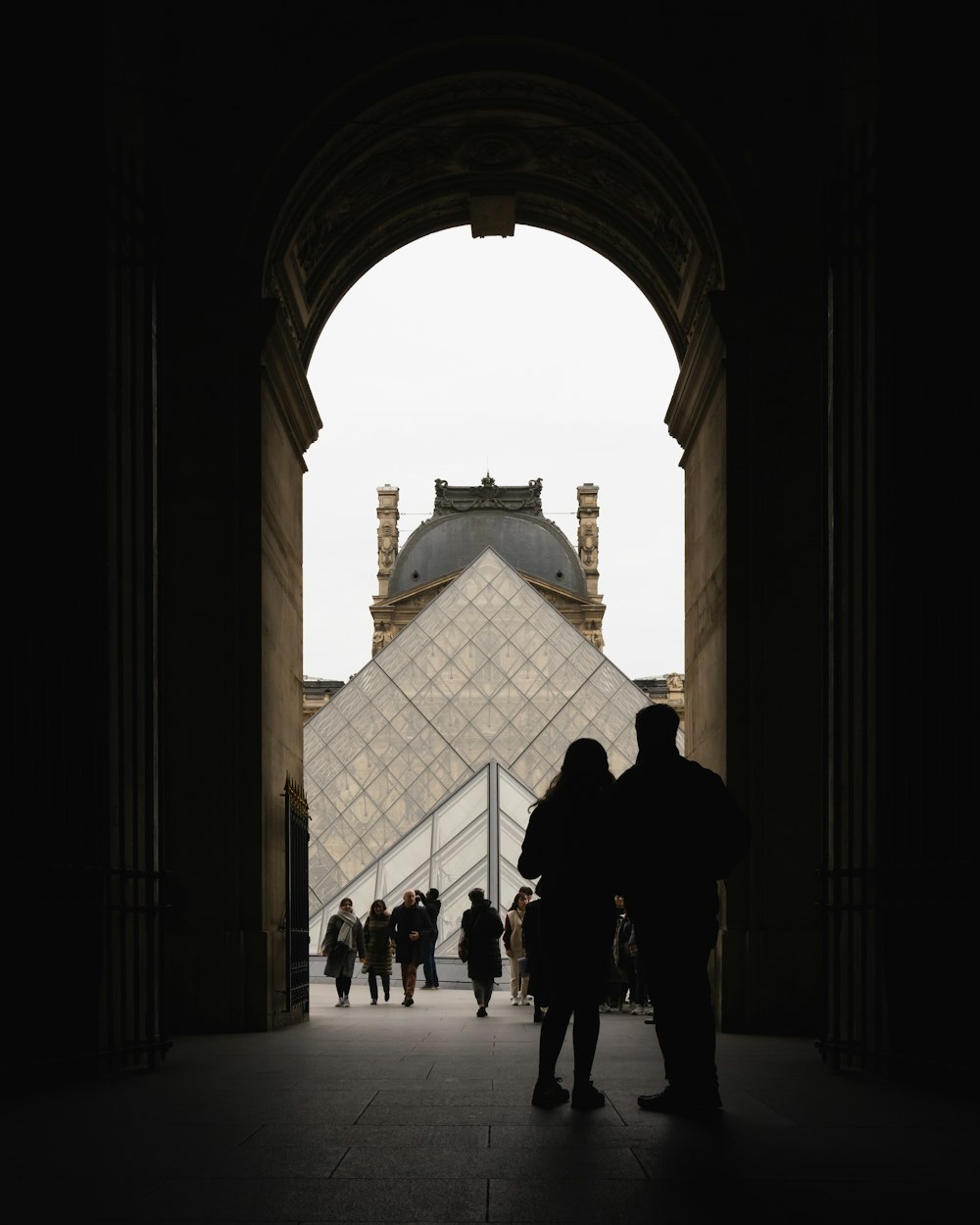 people walking on white concrete building during daytime