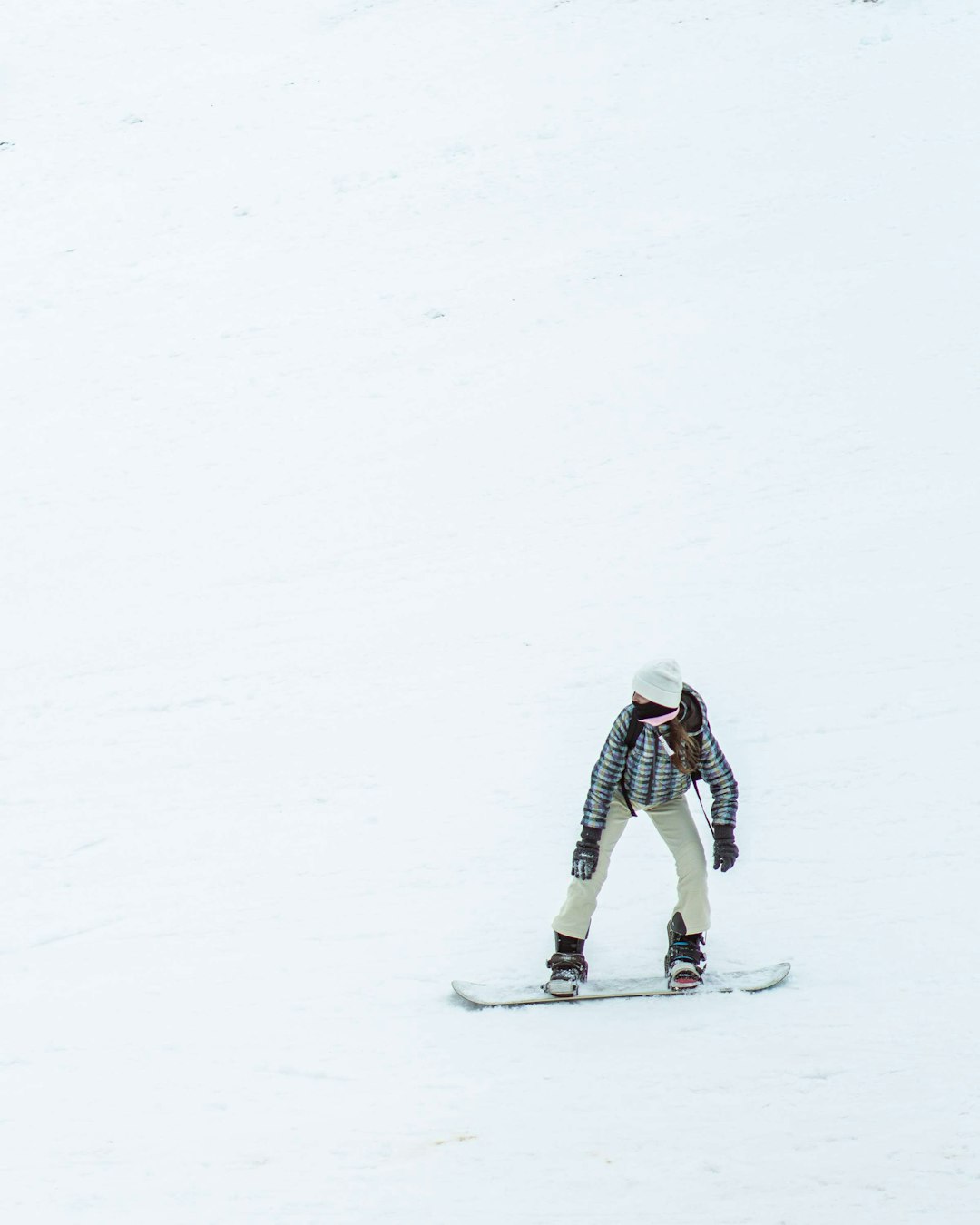 person in white jacket and black pants riding snow ski