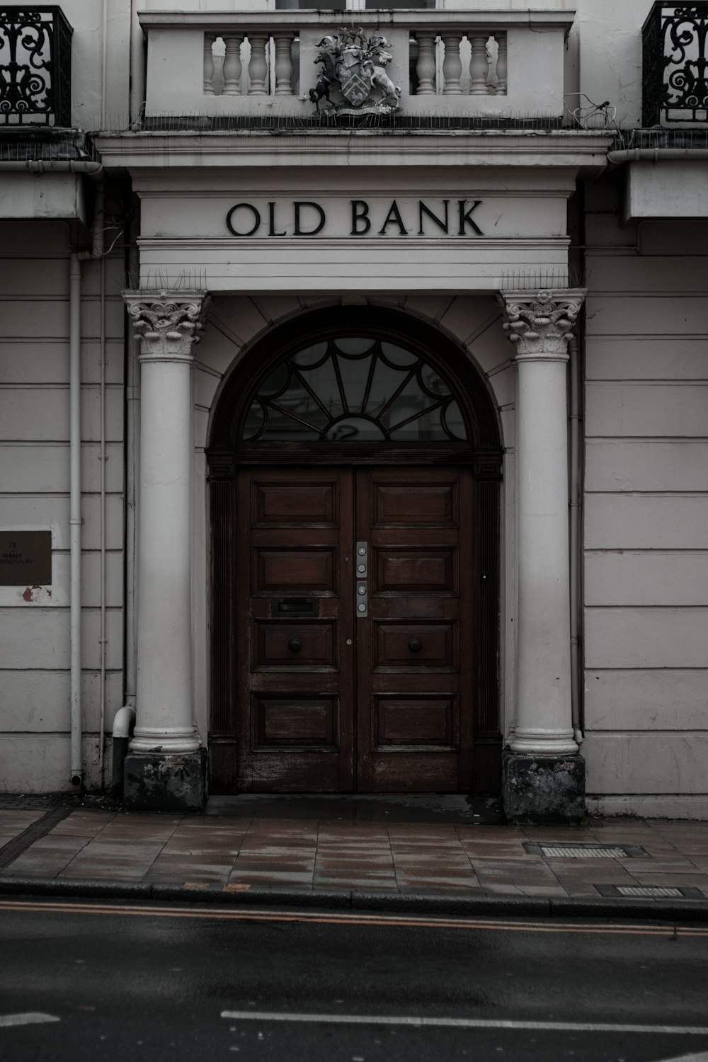 brown wooden door on white concrete building