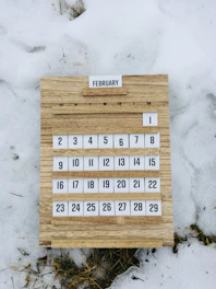 brown wooden board with white and black texts