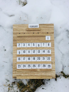 brown wooden board with white and black texts