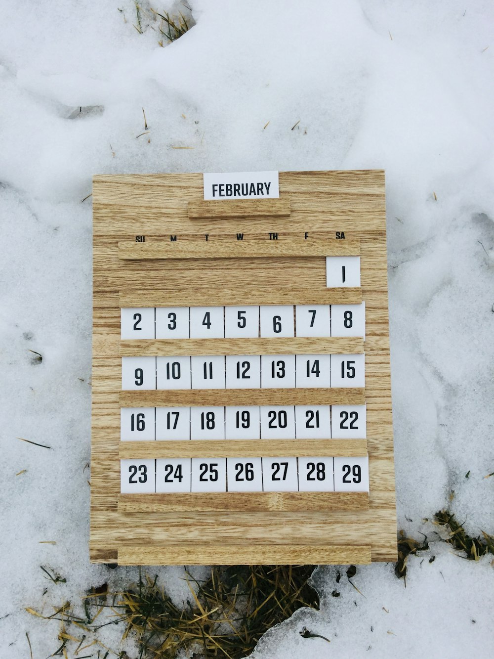 brown wooden board with white and black texts