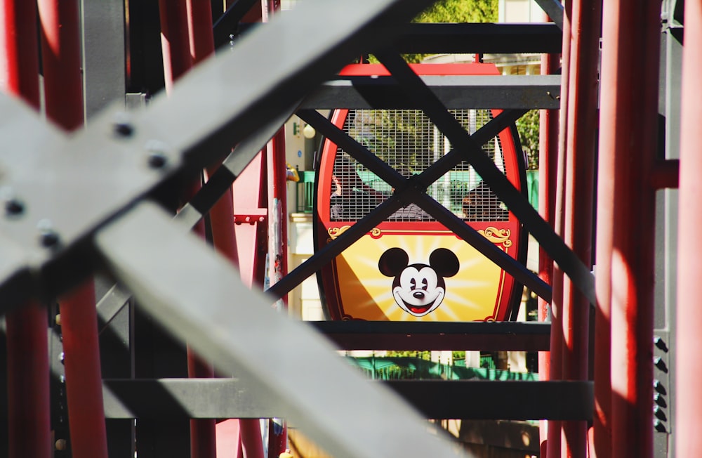 red and white mickey mouse themed metal fence