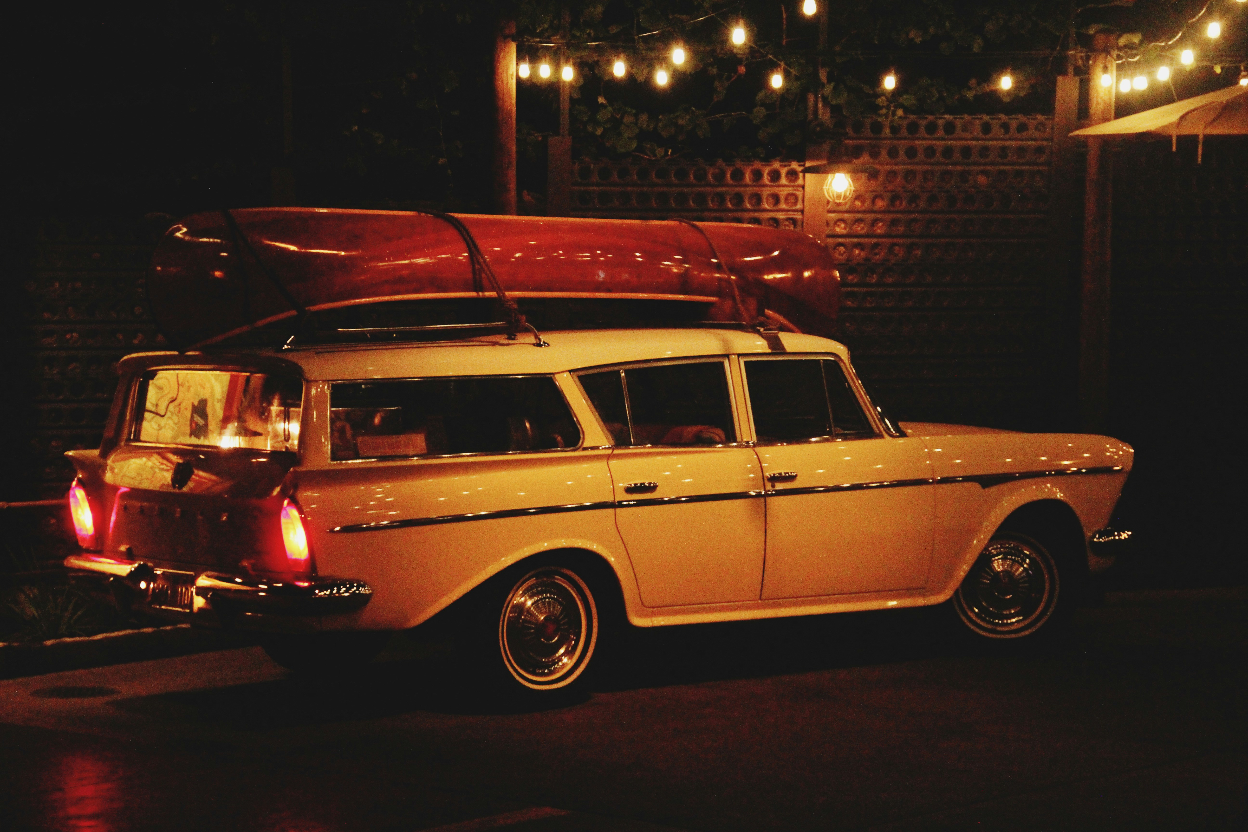 White and red station wagon on road during night time
