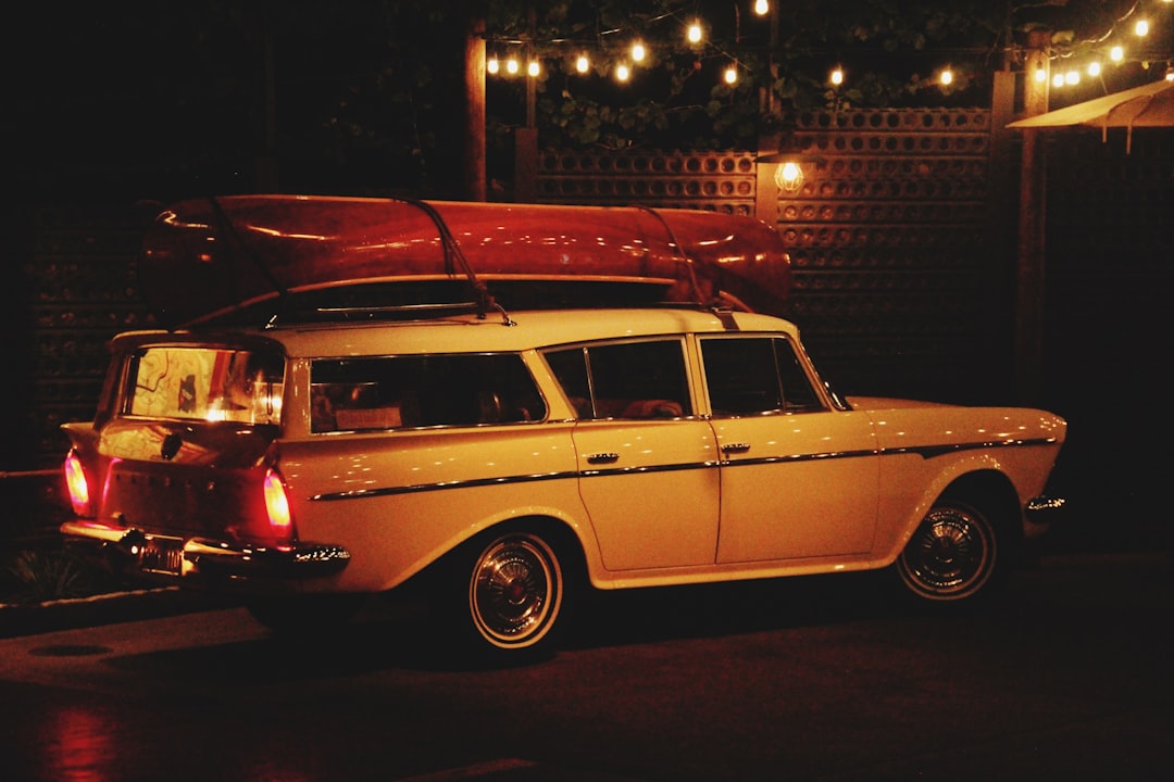white and red station wagon on road during night time