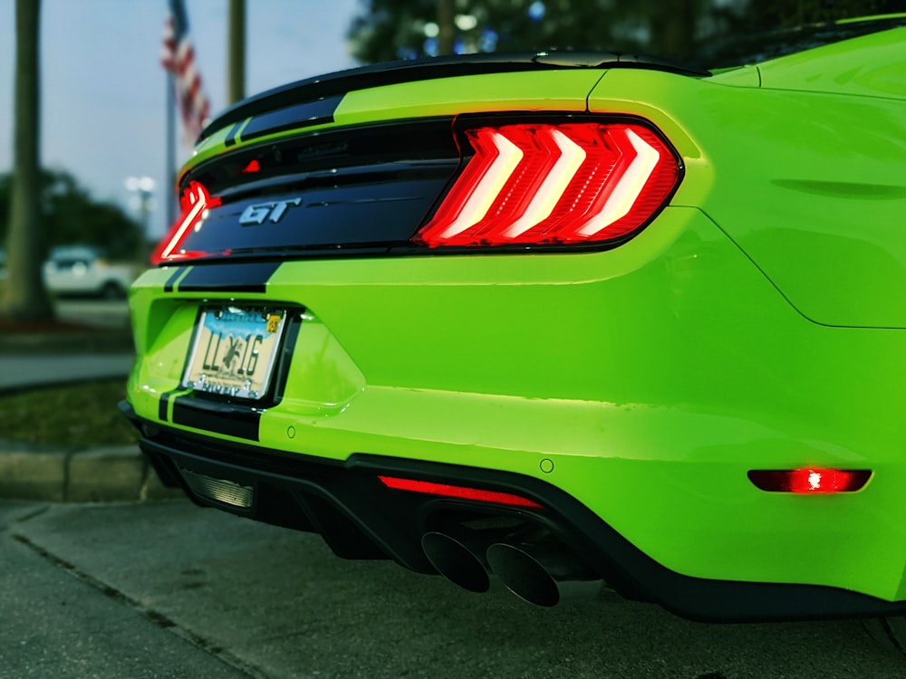 the tail lights of a neon green sports car
