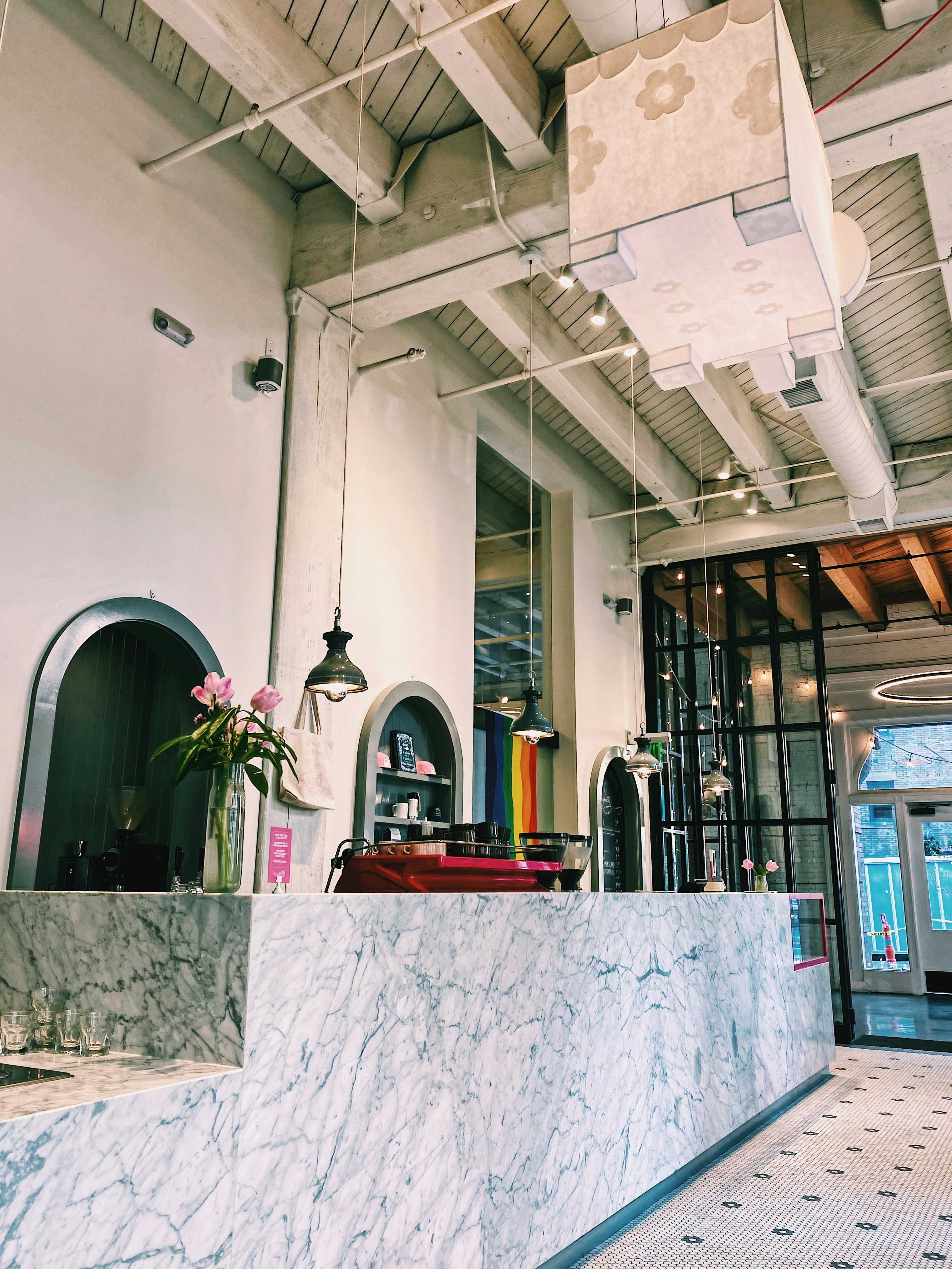 Upscale restaurant interior with rainbow flag decoration and diverse diners