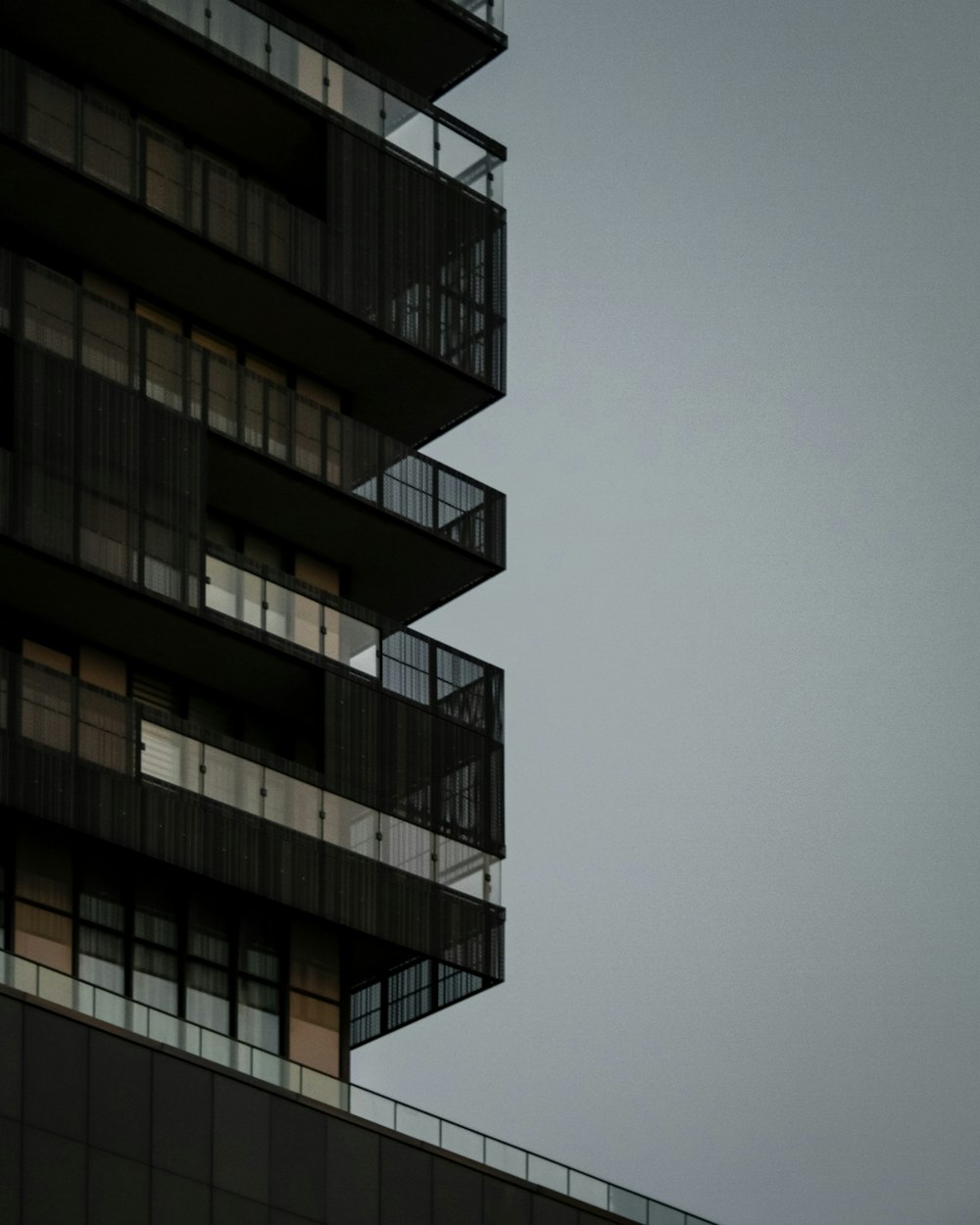 an airplane flying in the sky over a building