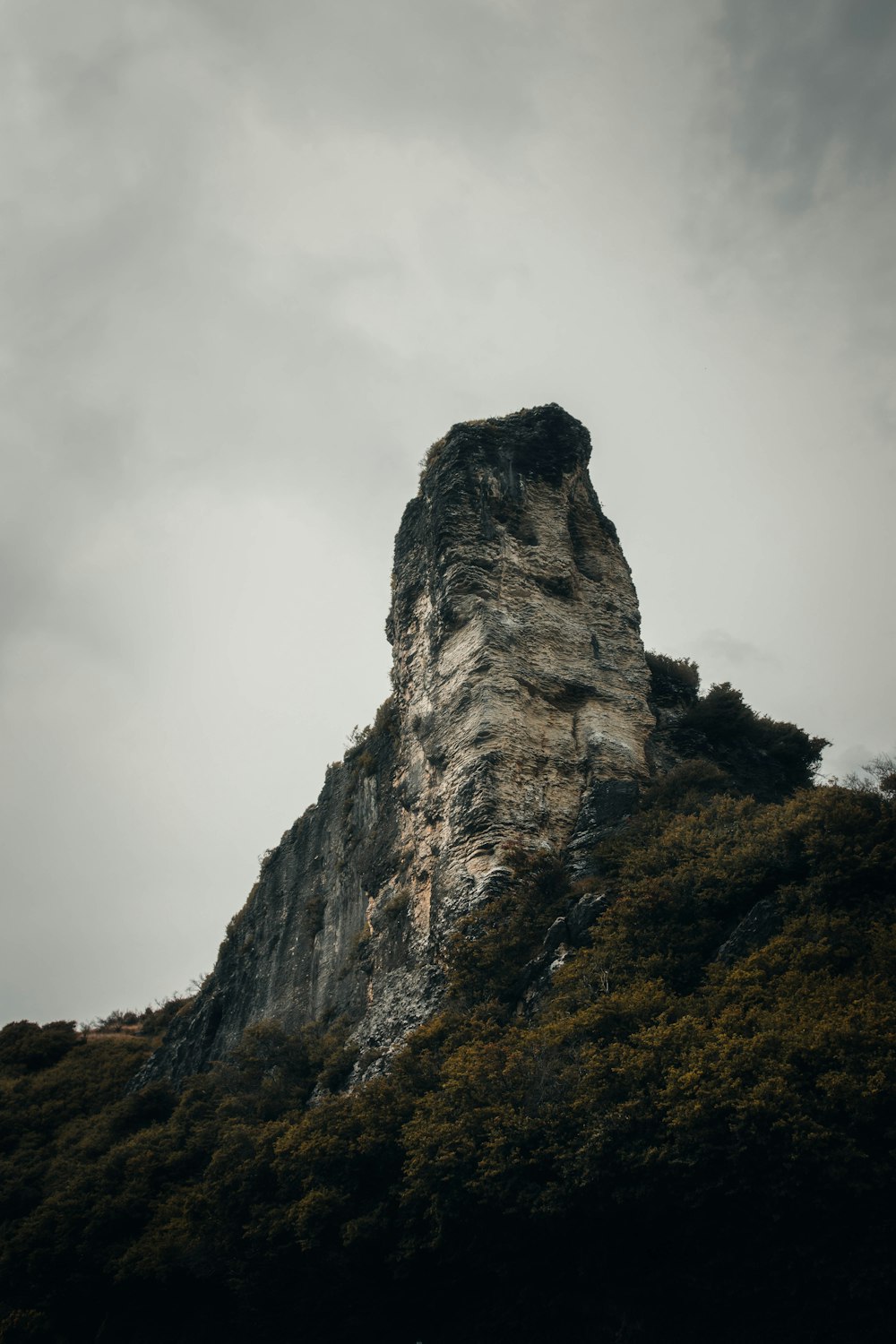 gray rock formation under white clouds