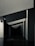 Geometric shapes and sharp angles create a modern architectural interior scene. The perspective of the image leads the eye through a series of receding plane segments, appearing as beams or dividers within the space. The lighting highlights the edges, adding depth to the darkened surroundings.