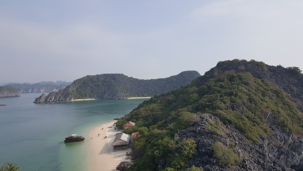 green mountain beside body of water during daytime