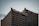 A tall office building with a grid-like pattern of windows is topped with signage that includes the words 'Heart & Stroke' and 'RBC CAN' with a red heart icon. The sky is overcast, creating a subdued atmosphere.