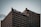 A tall office building with a grid-like pattern of windows is topped with signage that includes the words 'Heart & Stroke' and 'RBC CAN' with a red heart icon. The sky is overcast, creating a subdued atmosphere.