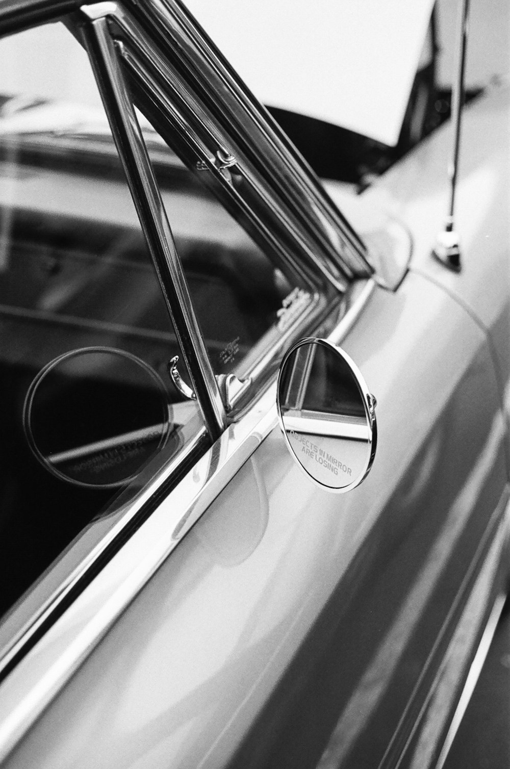 grayscale photo of car side mirror