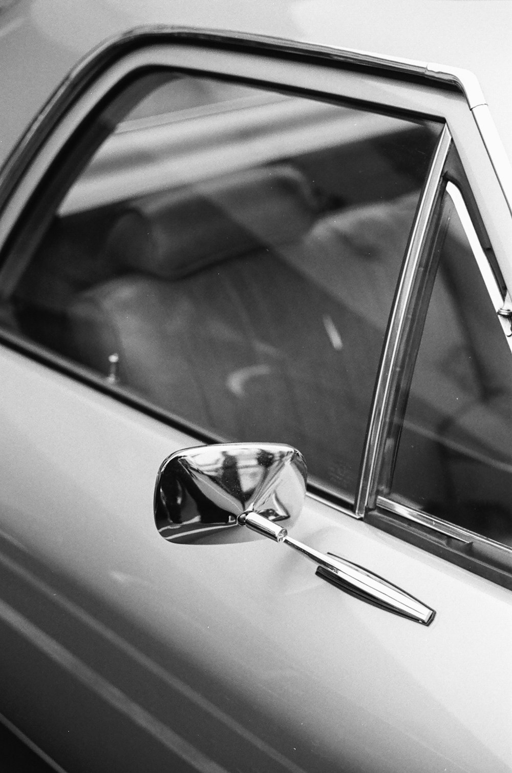 grayscale photo of car side mirror