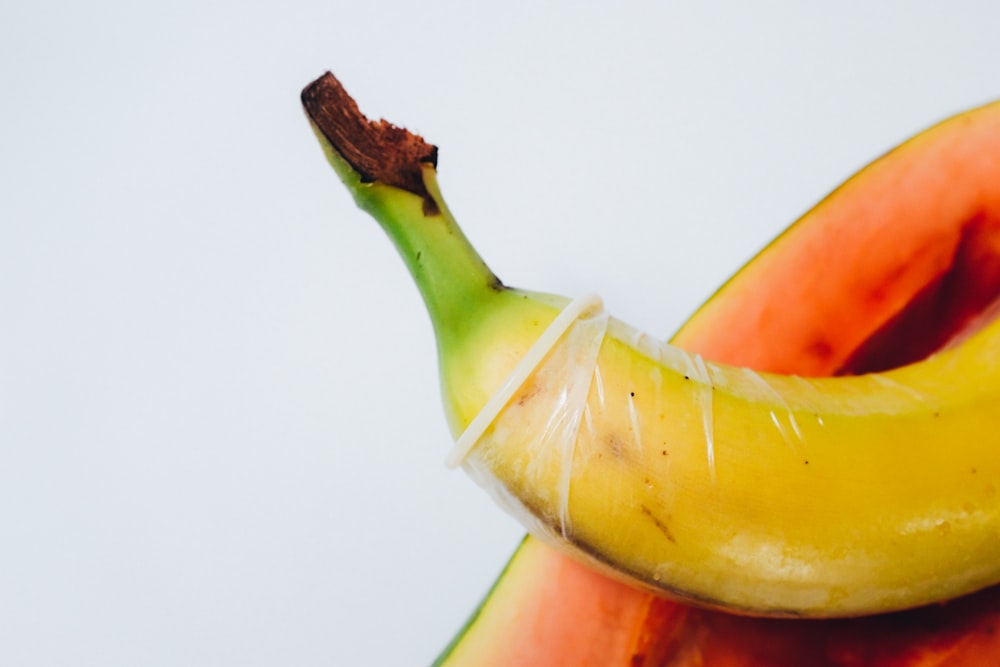 yellow banana fruit on white surface