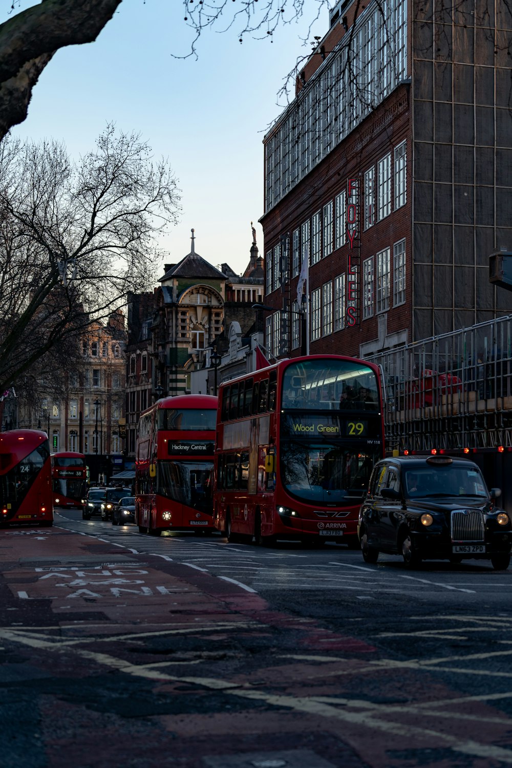 red double decker bus on road during daytime