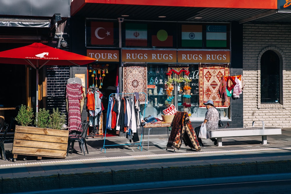 2 men standing near red and white store during daytime