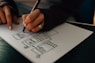 person writing on white paper