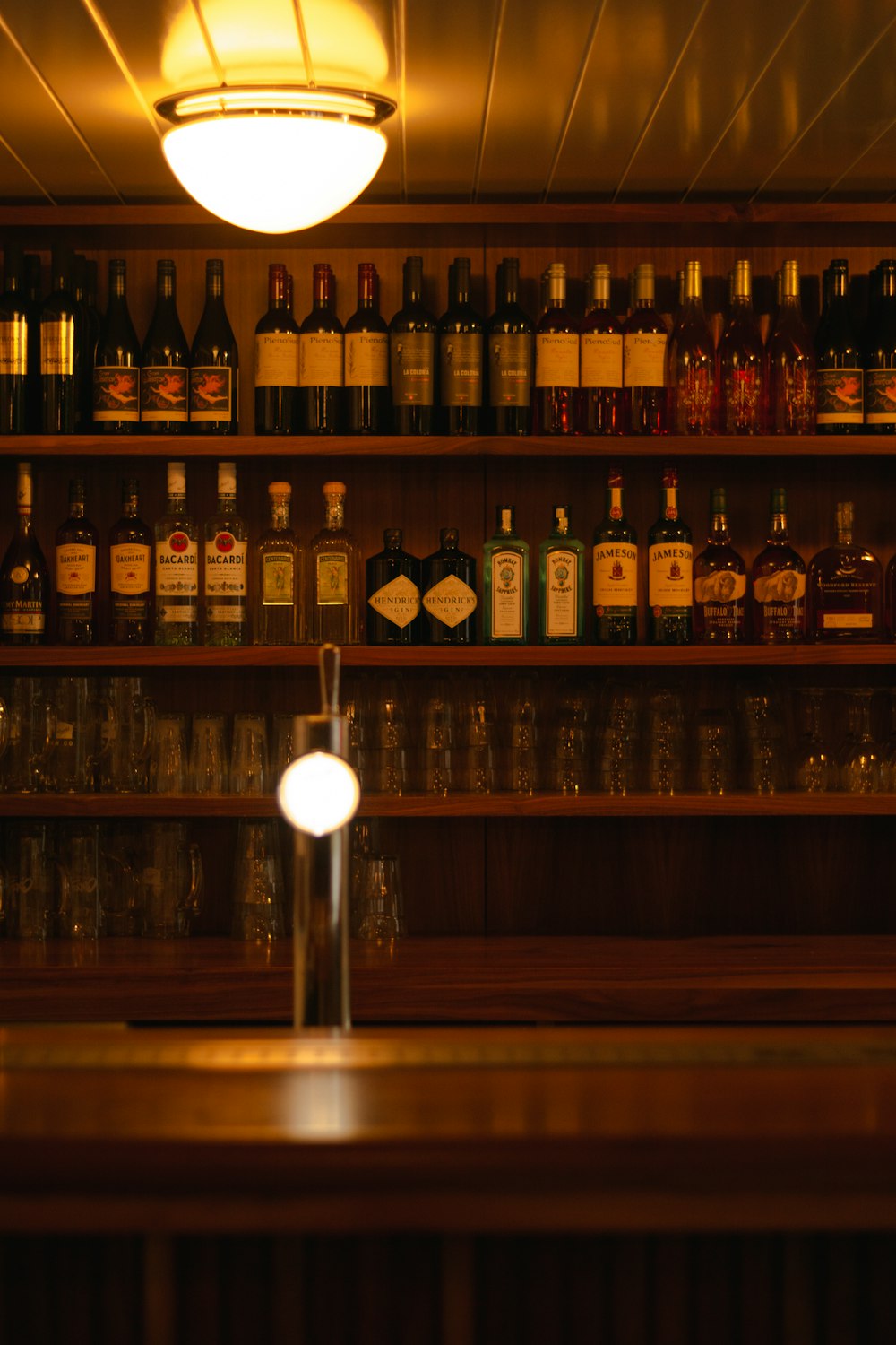 wine bottles on brown wooden shelf