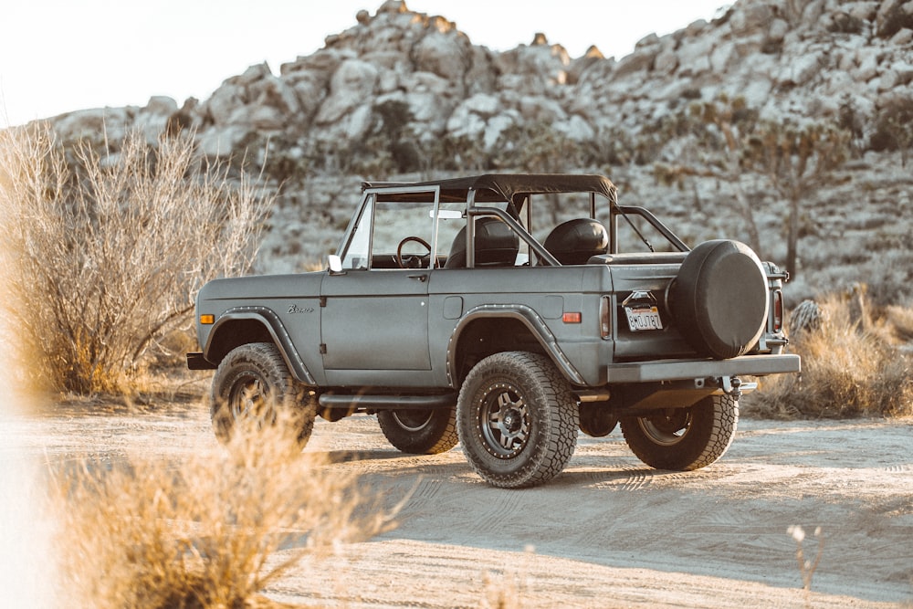 black and white jeep wrangler on brown field during daytime