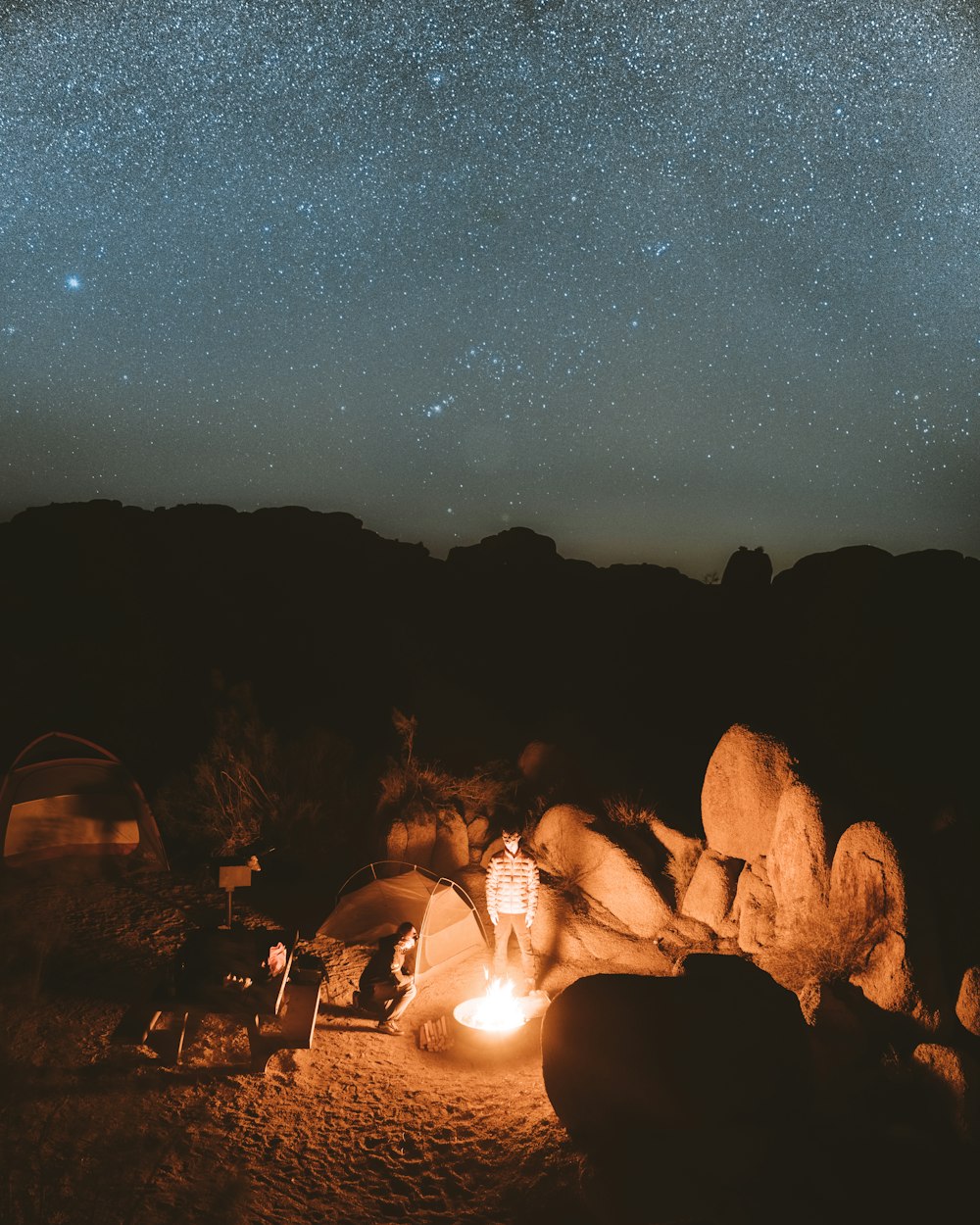 people sitting on rock formation during night time